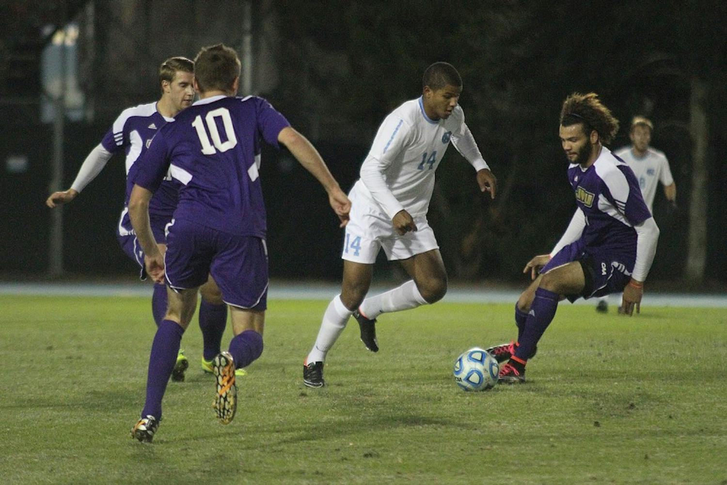 UNC midfielder Omar Holness (14) takes control of the ball. Holness had one assist on Thursday.