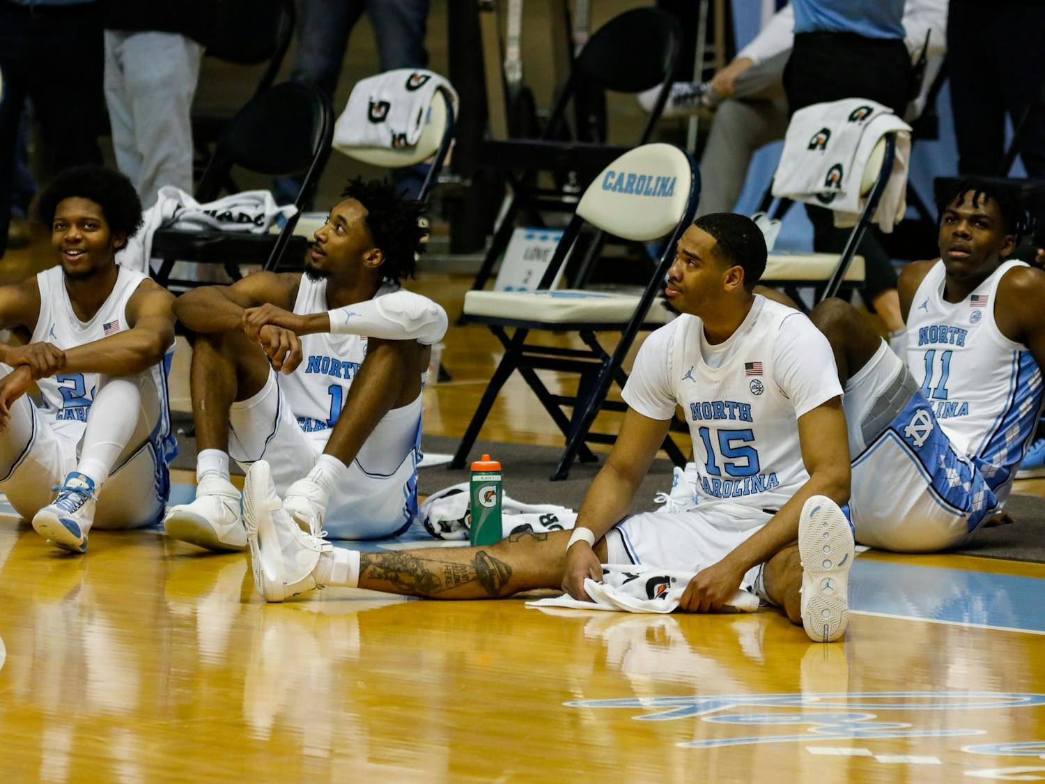 UNC senior forward Garrison Brooks (15) sits on the floor during senior night speeches in the Dean Dome on March 6, 2021. The Tar Heels beat the Blue Devils 91-73.