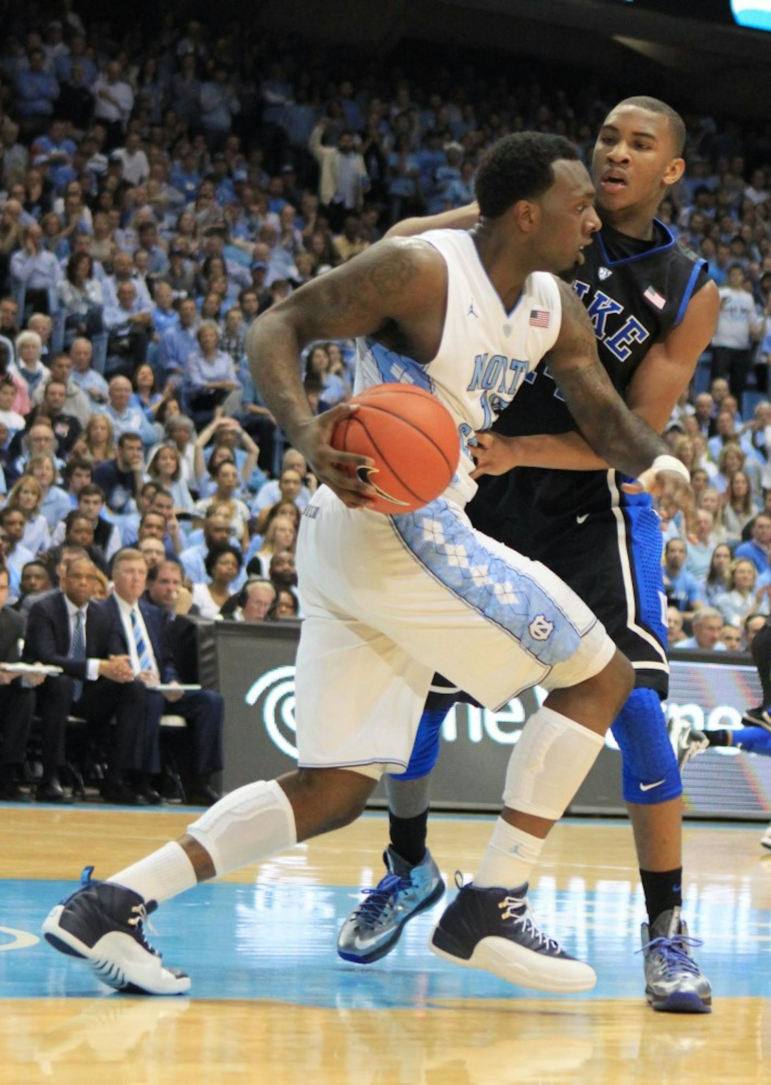 	P.J. Hairston drives the ball down the court. 