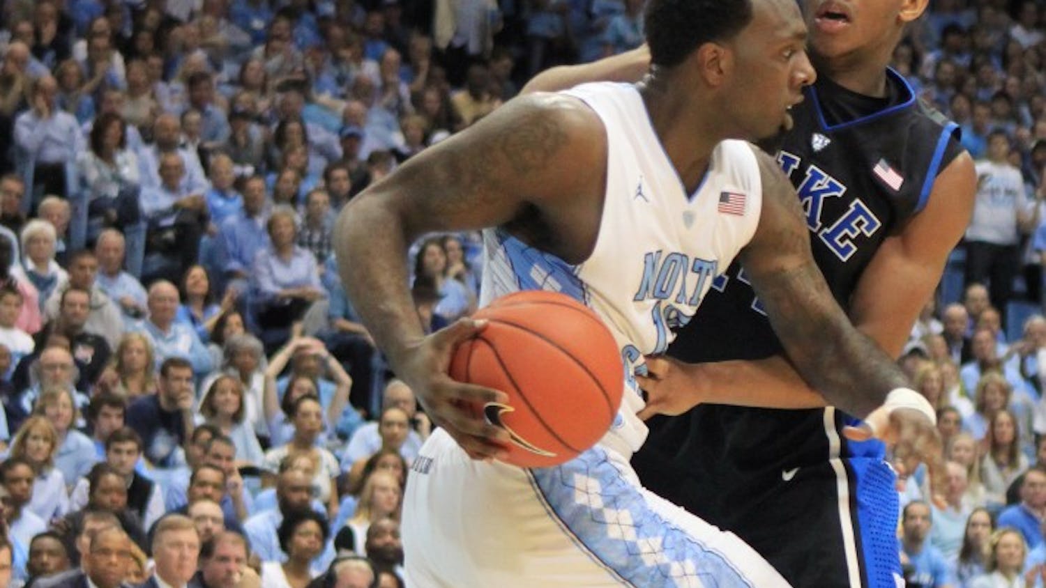 	P.J. Hairston drives the ball down the court. 