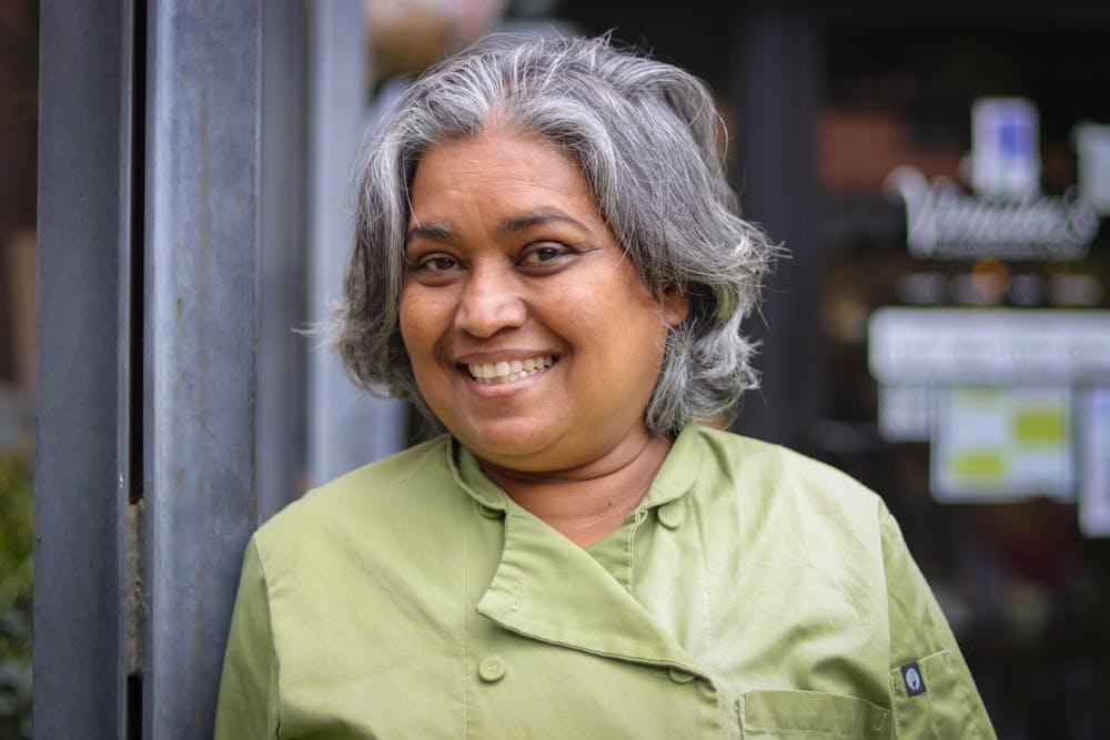 Vimala Rajendran is the chef and founder of Vimala's Curryblossom Café in downtown Chapel Hill. She poses outside of her restaurant on Monday, April 19.