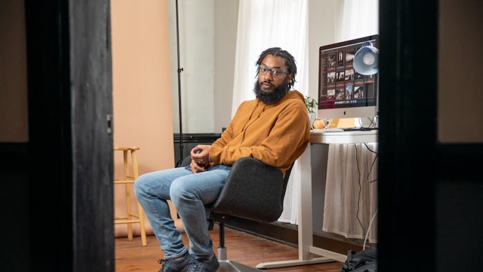 Cornell Watson, the photographer behind "Tarred Healing," poses for a portrait in his Durham office on Saturday, Feb. 26, 2022. "Tarred Healing" is a photo story reflecting on Black history in Chapel Hill and at UNC.&nbsp;