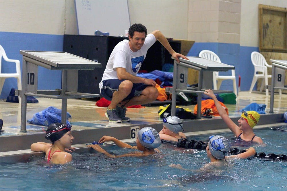Hillsborough Aquatic Club head coach and former UNC swimmer Vinny Pryor encourages some of his swimmers on Tuesday night.