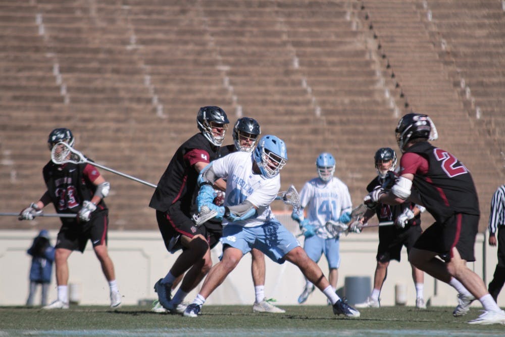 <p>Senior Chris Cloutier (45) rears back for a shot against Lafayette on Feb. 3 in Kenan Stadium.</p>