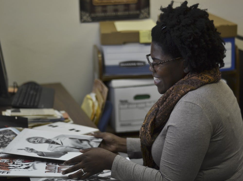 African American collections archivist Chaitra Powell studies a new shipment of documents at Wilson Library. 