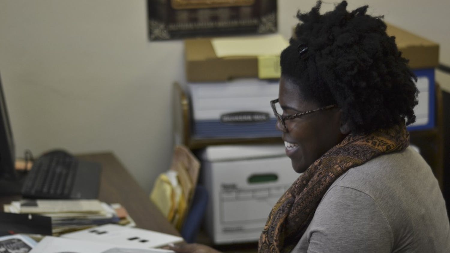 African American collections archivist Chaitra Powell studies a new shipment of documents at Wilson Library. 