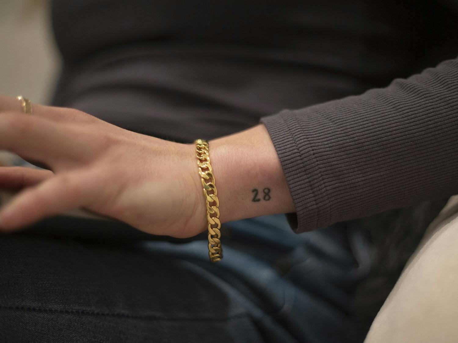 Alexa Casciano sits in her friend’s living room on February 2, 2021. Casciano was in the hospital for 28 days when she was sixteen. The experience changed her outlook on life. Casciano said, “I actually have this tattoo of 28, and again it kind of reminds me that if I can go through that 28 days, I can do anything.” Photo courtesy of Dana Gentry.