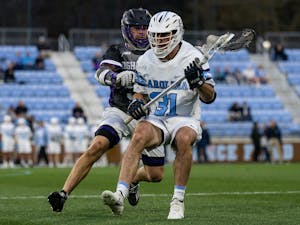UNC graduate midfielder Connor Maher (31) runs with the ball during the men's lacrosse game against High Point on Wednesday, March 22, 2023, at Dorrance Field. UNC beat High Point 16-9.