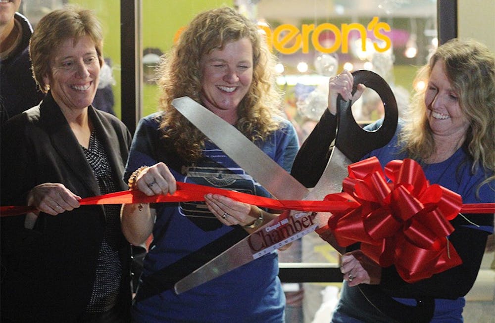 	Carrboro Mayor Elect Lydia Lavelle cuts the ribbon at the grand opening of Cameron’s with co-owners Wendy Smith and Bridget Pemberton-Smith. Cameron’s is the first business to move into 300 East Main.
