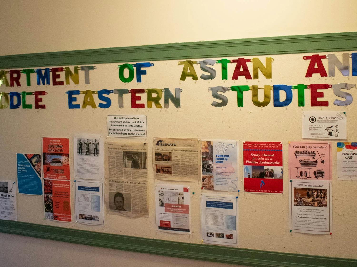 Posters decorate the UNC Department of Asian and Middle Eastern studies bulletin board on Monday, March 27, 2023.