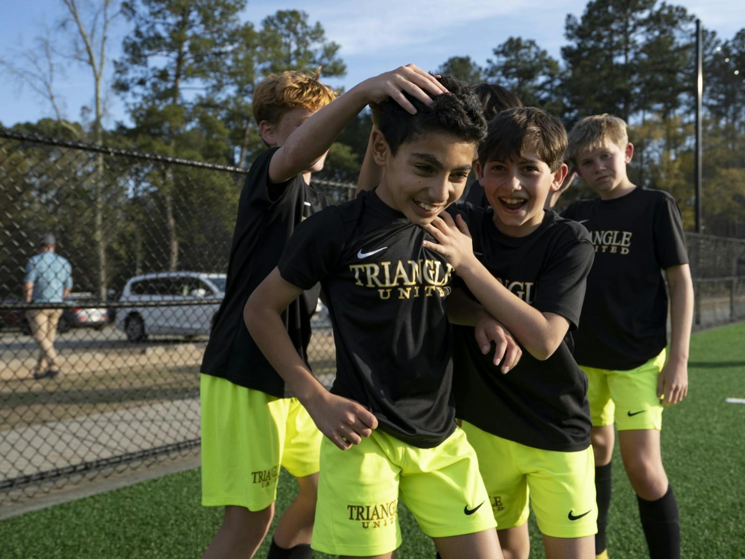 Players with Triangle United Soccer Association celebrate together after making an inaugural goal on their new turf. The Town of Chapel Hill held a ribbon cutting ceremony on Thursday, Mar. 23, 2023, at Cedar Falls Park in Chapel Hill, N.C. to celebrate the freshly-redone, environmentally-friendly turf for the multi-purpose field.
