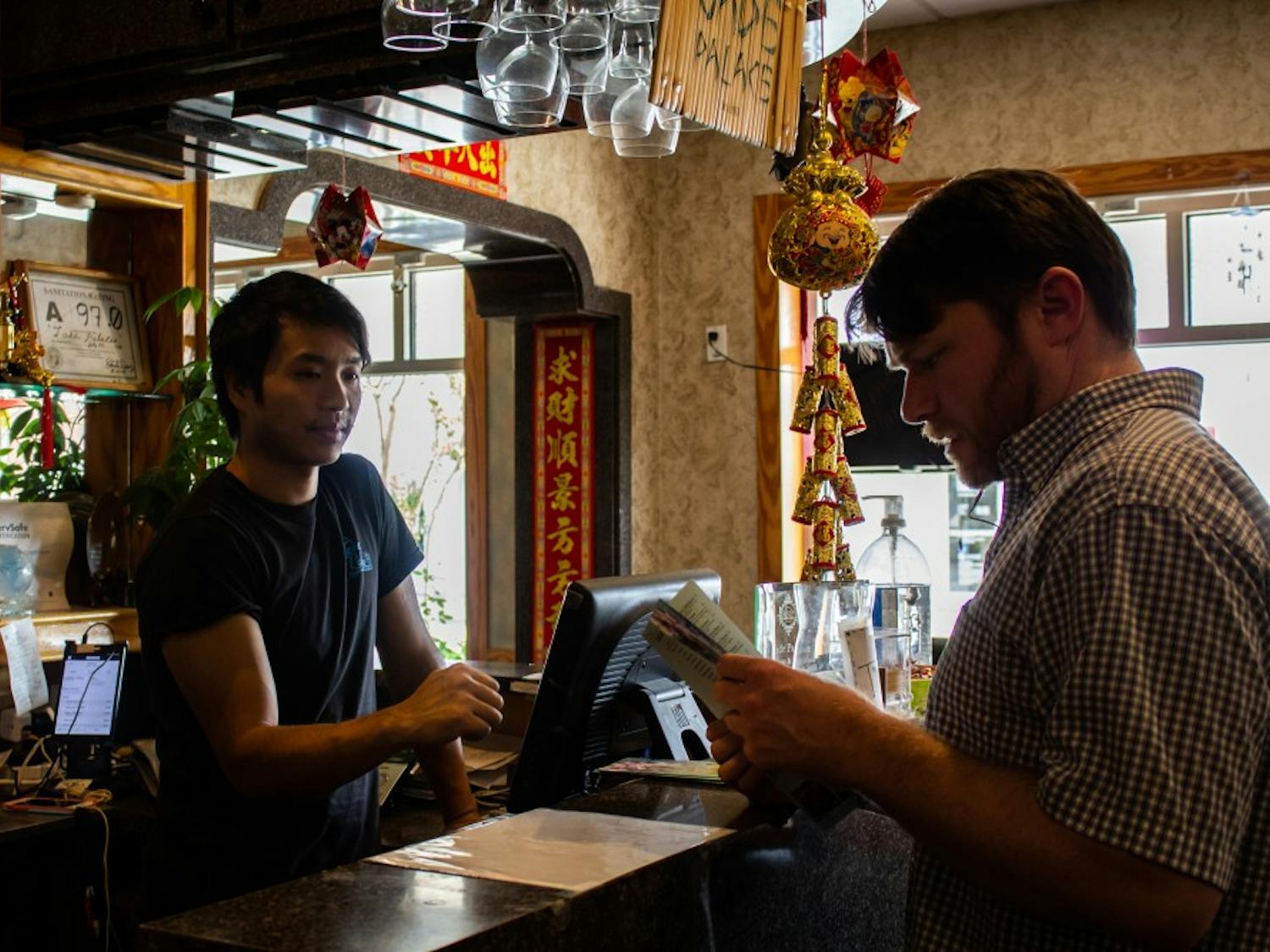 Kevin Wang, age 36 and owner of the Jade Palace restaurant, takes a customer's order on Tuesday, Oct. 1, 2019.&nbsp;