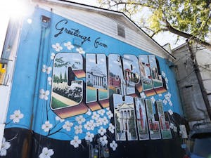 The "Greetings from Chapel Hill" postcard mural located behind He's Not Here, pictured on Tuesday, Oct. 18, 2022.