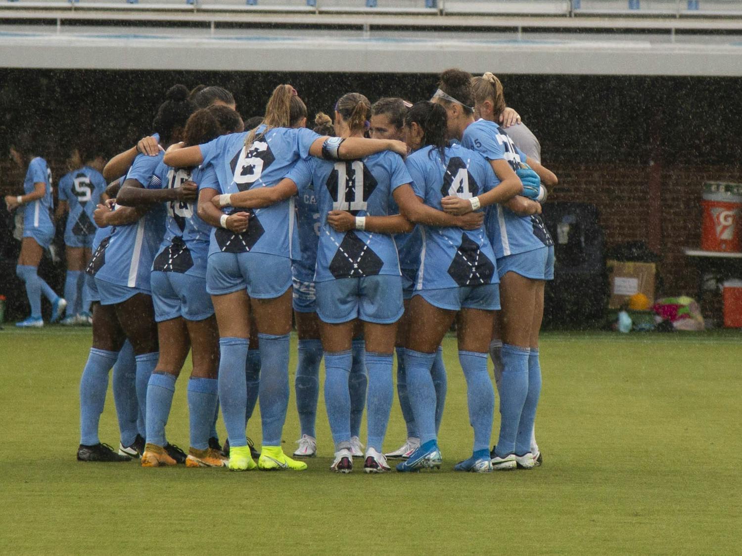 UNC women’s soccer team huddles before the start of their game against Wake Forest at Dorrence Field on Thursday, Sep. 17, 2020. UNC defeated Wake Forest with a final score of 4-1. Two of the goals were scored by junior forward Brianna Pinto, number eight, and the other two by junior forward Rachel Jones, number 10.