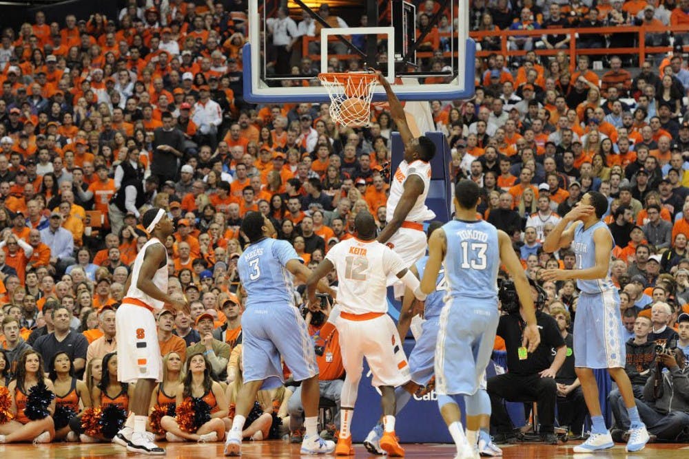 UNC men’s basketball players watch as former Syracuse forward Jerami Grant dunks in a game. Courtesy of The Daily Orange.