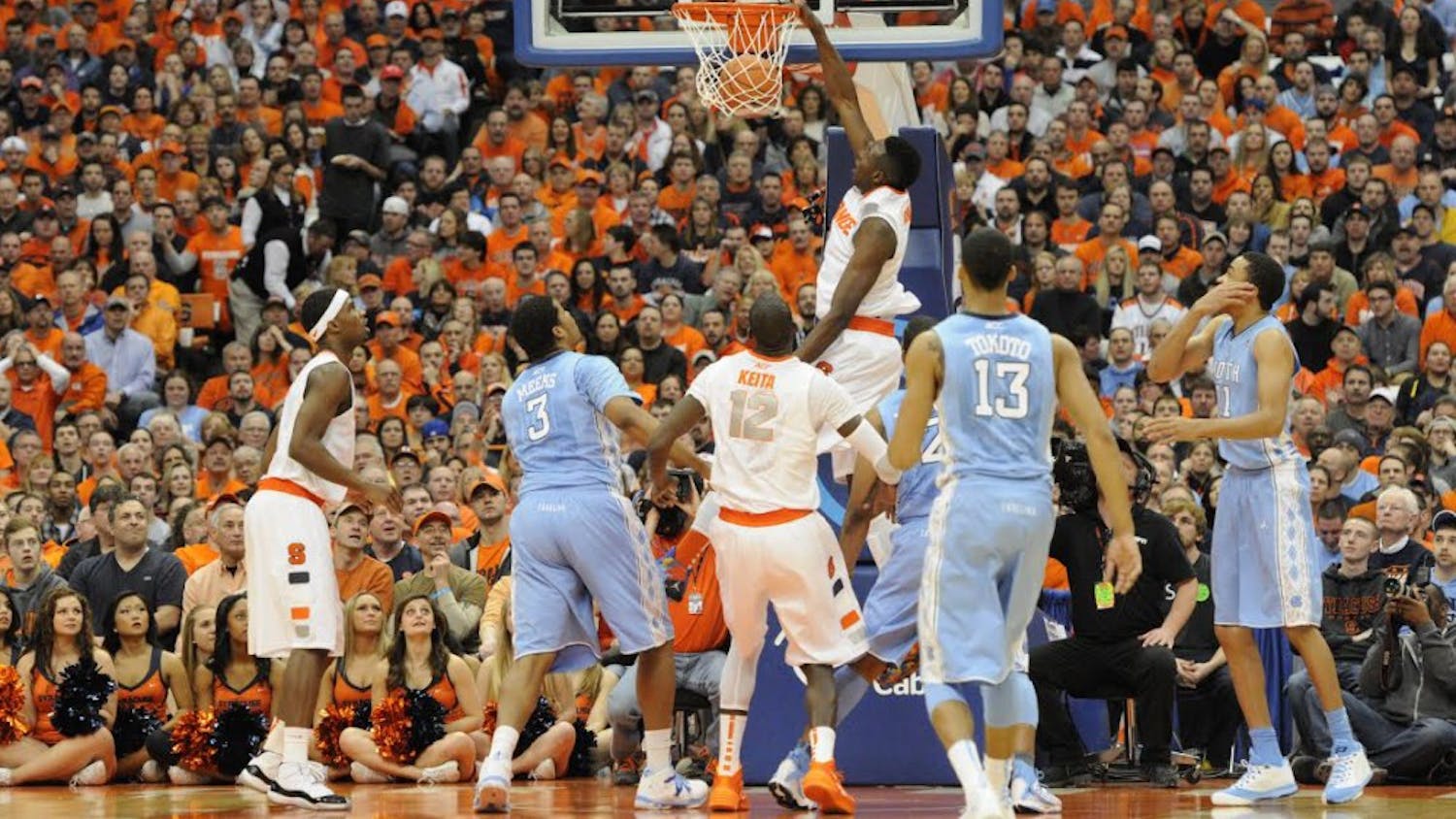 UNC men’s basketball players watch as former Syracuse forward Jerami Grant dunks in a game. Courtesy of The Daily Orange.