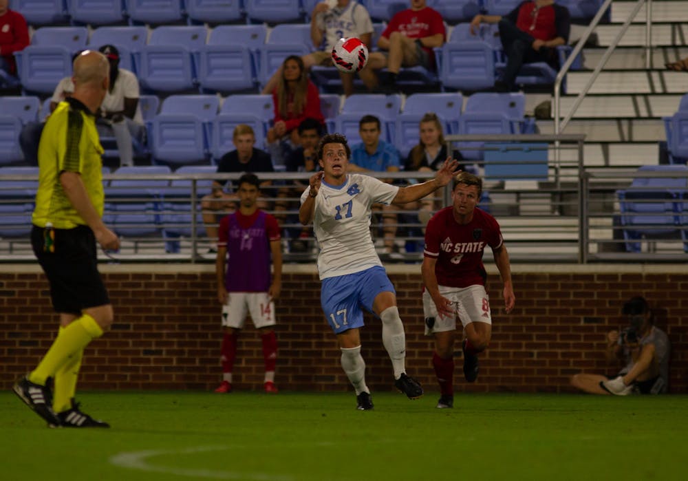 UNC junior midfielder Cameron Fisher (17) headbutts the soccer ball in the game against NC State at Dorrance Field on Oct. 3. The Tar Heels won 4-0.