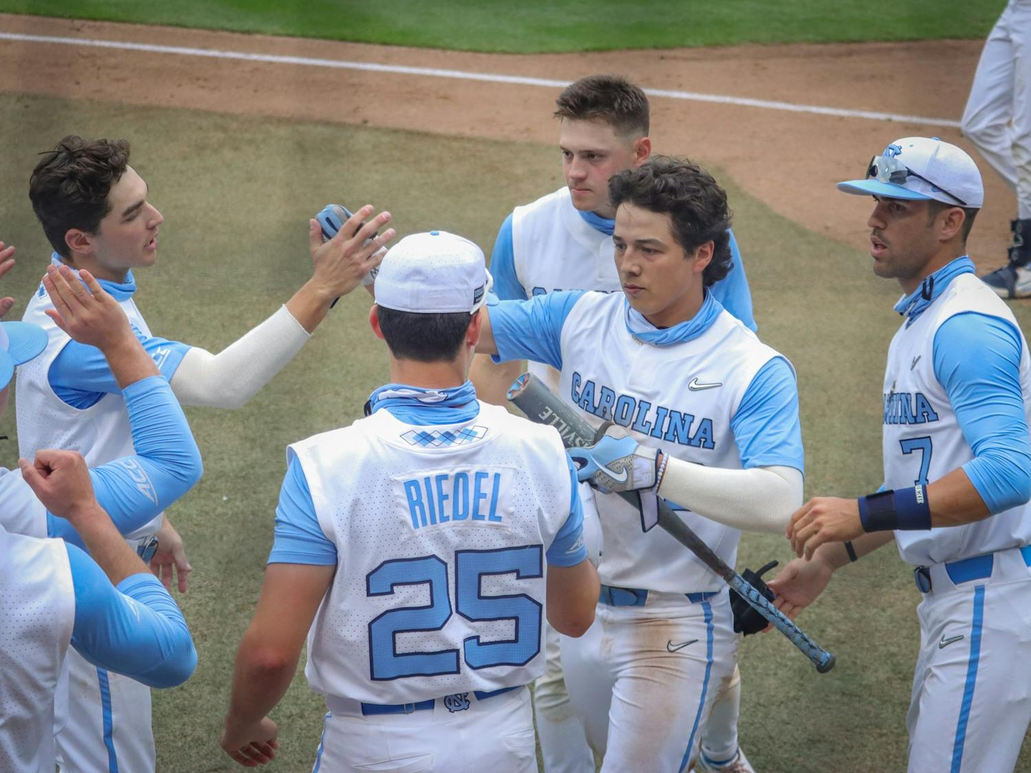 UNC sophomore outfielder Angel Zarate (40) is congratulated by his teammates for his home run during the Tar Heels' 1-6 loss against N.C. State on Saturday, March 27, 2021 in Boshamer Stadium in Chapel Hill, N.C. Zarate's home run was UNC's only score during the game.