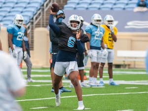 First year quarterback Jacolby Criswell (6) throws the ball at the football practice on Saturday Mar. 27, 2021 at Kenan Stadium.
