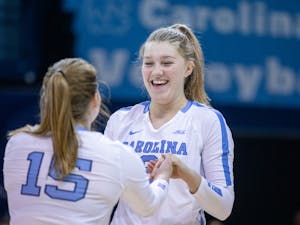 Freshman outside hitter Mabrey Shaffmaster (9) celebrates with her teammate, senior libero/defensive specialist Ryan Shannon (15), during the game against Notre Dame on Nov 5. UNC lost in three sets.
