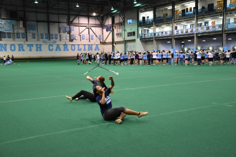 UNC majorettes Ava Smith (left) and Ciara Gillis (right) rehearse during marching band practice in the Eddie Smith field house.