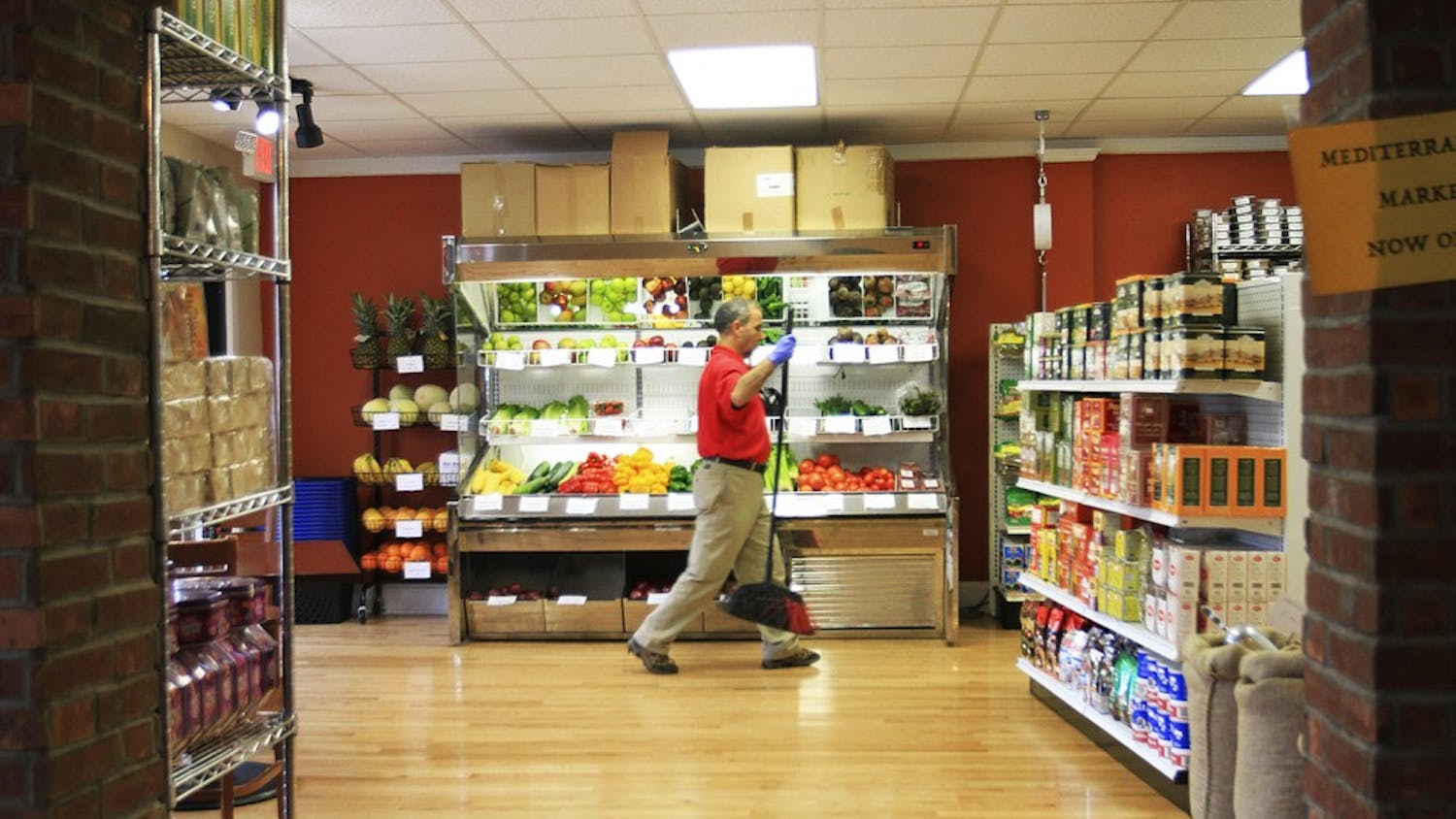 Mohamed Jamili tends to the newly opened Mediterranean Market located within Med Deli on West Franklin Street.