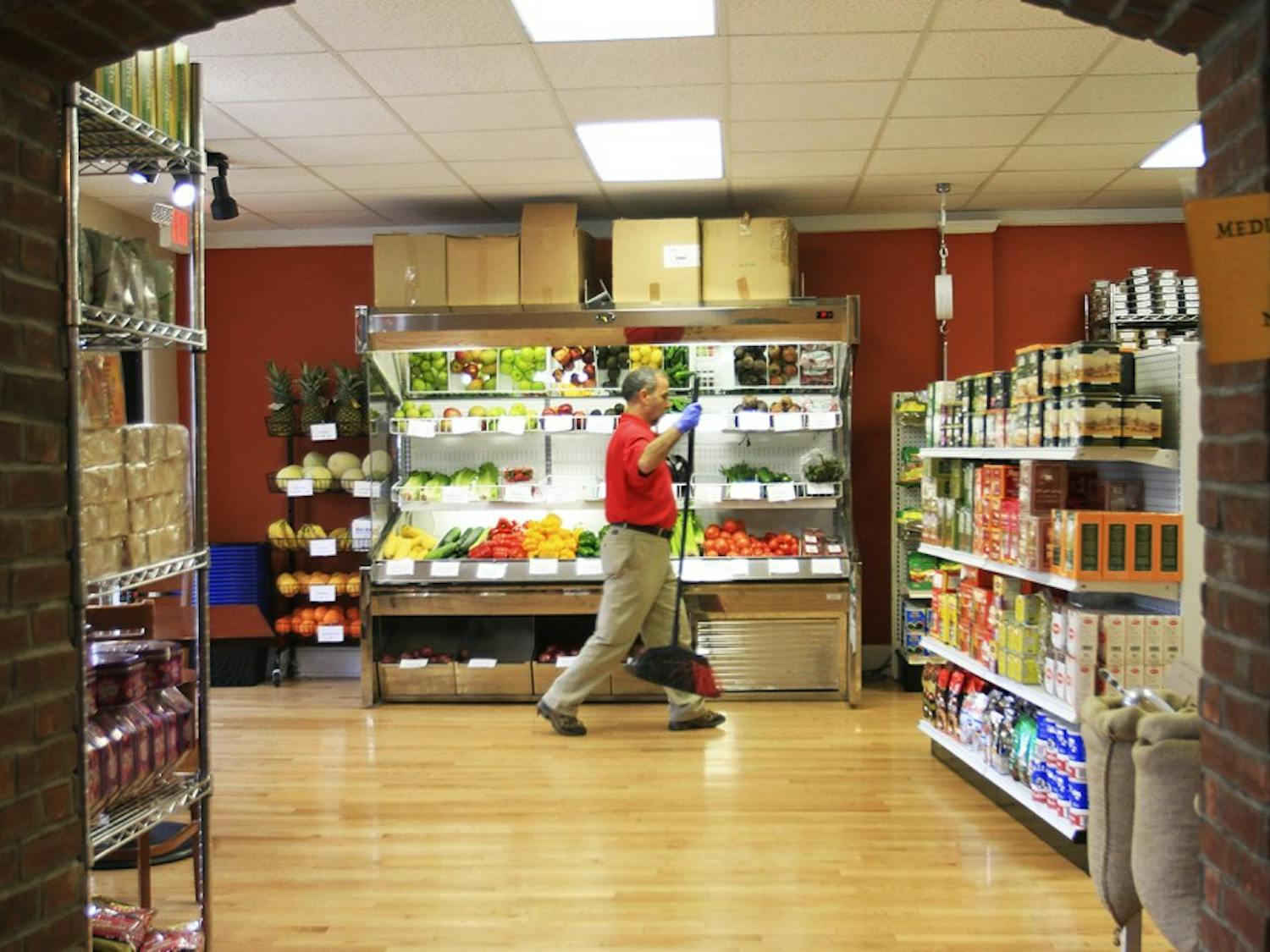 Mohamed Jamili tends to the newly opened Mediterranean Market located within Med Deli on West Franklin Street.