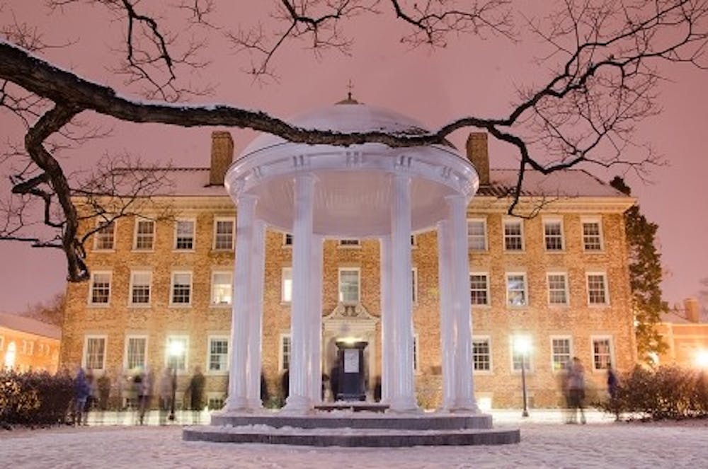 Students gather around the Old Well to enjoy the snow in January 2014.