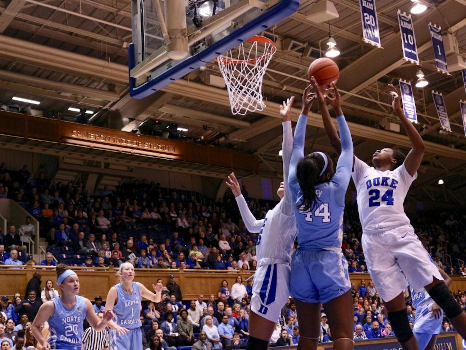 Duke forward Onome Akinbode-James (24) attempts to shoot for the basket against UNC sophomore center Janelle Bailey (44) in Cameron Stadium on Sunday, March 3, 2019.The Tar Heels lost to the Blue Devils with a score of 44-62.