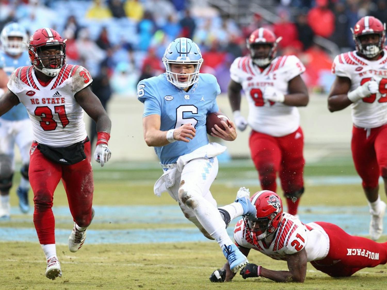 Cade Fortin (6) rushes against NC State on Saturday, Nov. 24, 2018 in Kenan Memorial Stadium. NC State beat UNC 34-28 in overtime.
