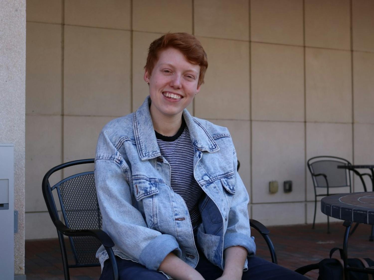 Senior Brennan Lewis sits in front of the Union on Friday, March 22, 2019. Brennan helped to found Queer NC when they were in high school, which is an organziation that hosts events and activities for LGBTQ youth.