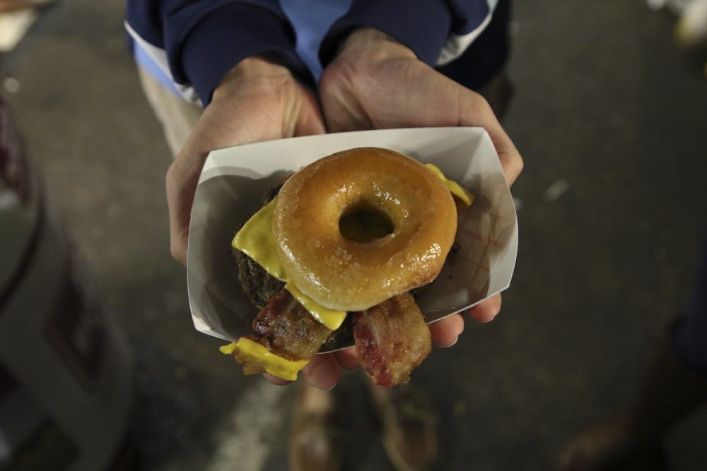 <p>Krispy Kreme burgers are one of many unique foods one can find at the N.C. State Fair.</p>