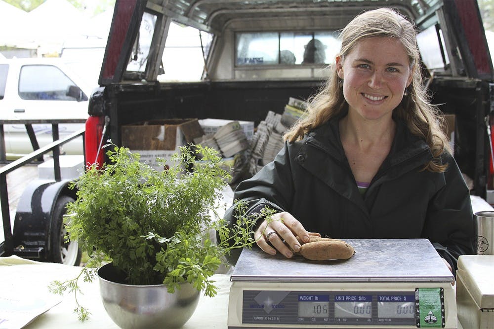 <p>Jamie Murray, owner of Sunset Farms in Snow Camp, weighs potatoes at the Carrboro Farmers’ Market, which is funded by donations.</p>