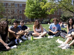 A group of students pose for a photo at Polk Place on Tuesday, April 4, 2023. Forming friendships and communities, especially after graduation, is all about intention.