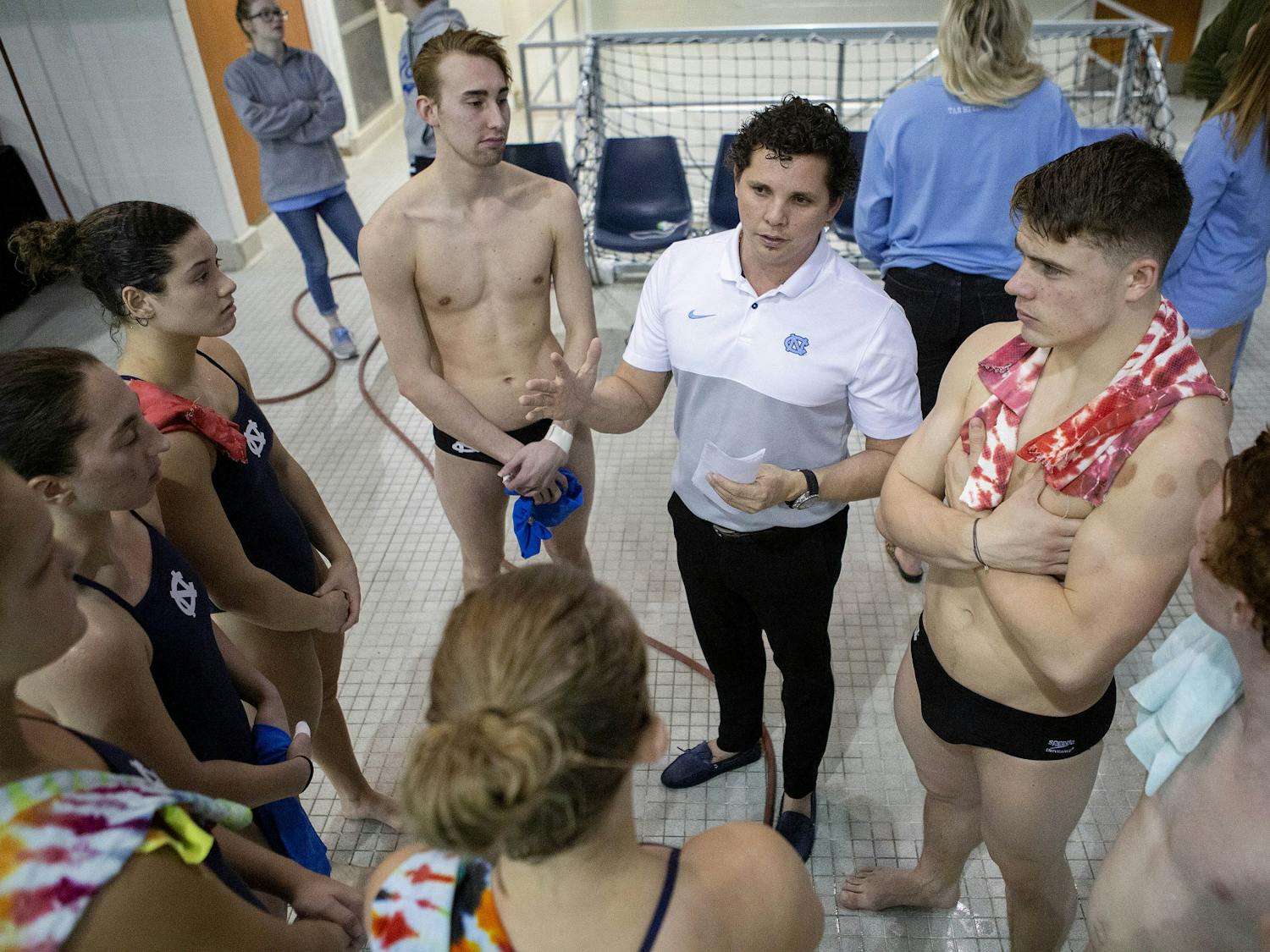 UNC head diving coach Yaidel Gamboa talks to athletes before a game against NC State at Koury Natatorium on Friday, Jan. 17, 2020. Photo courtesy of Barron Northrup.
