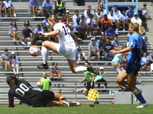 The UNC soccer team defeated UCLA 3-1 on Sunday Sept. 13. Forward Jessie Scarpa (12) finds a way around UCLA keeper Arielle Schechtman (00) to score her second goal of the game and bring the score to 3-1.