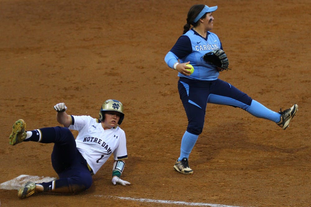 Berlynne Delamora attempts to throw out a base runner during Monday night's game against Notre Dame.