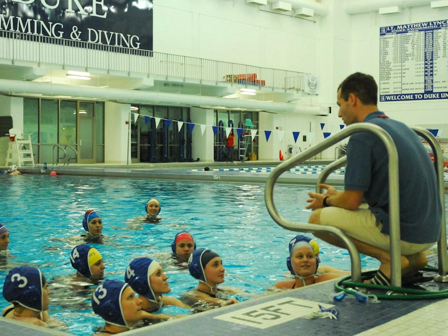 UNC women’s club water polo coach Marty Schoen gives a pep talk before its scrimmage against Duke University. DTH/Lauren Vied