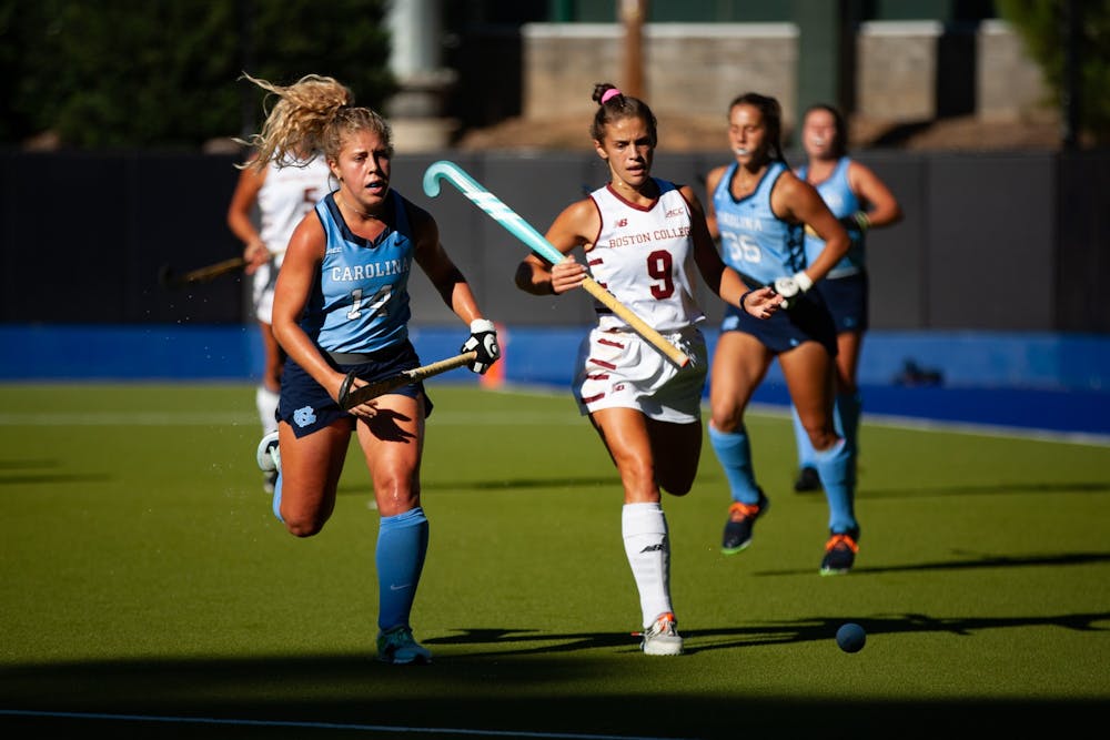 In the Sept. 24 field hockey match against Boston College, sophomore midfielder/fullback Katie Dixon (14) races for the ball against a Boston College defender. At half-time, UNC was winning 2-0.