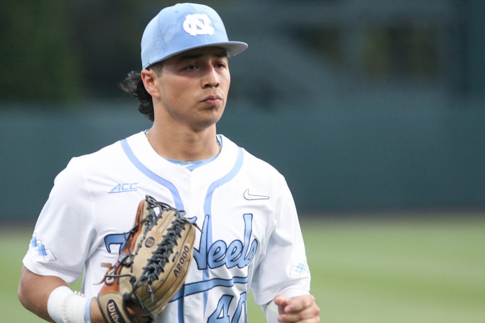 UNC junior outfielder Angel Zarate (40) returns to the dugout during a home game at Boshamer Stadium against Appalachian State on Tuesday, March 22, 2022.