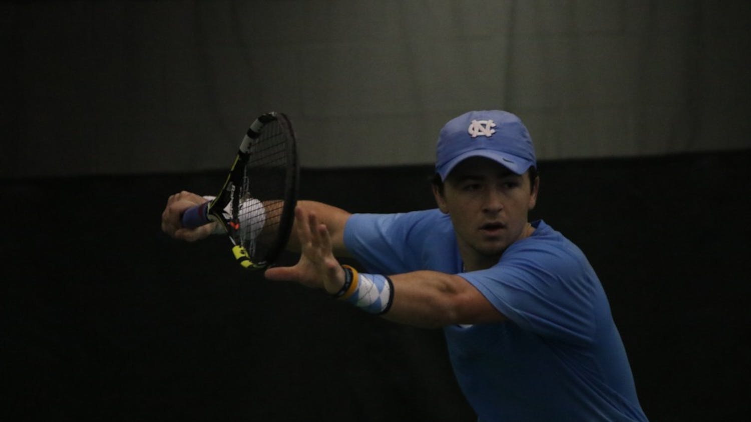 Junior Ronnie Schneider prepares to return a volley with a forehand hit in UNC men's tennis's route of Wofford on Sunday.