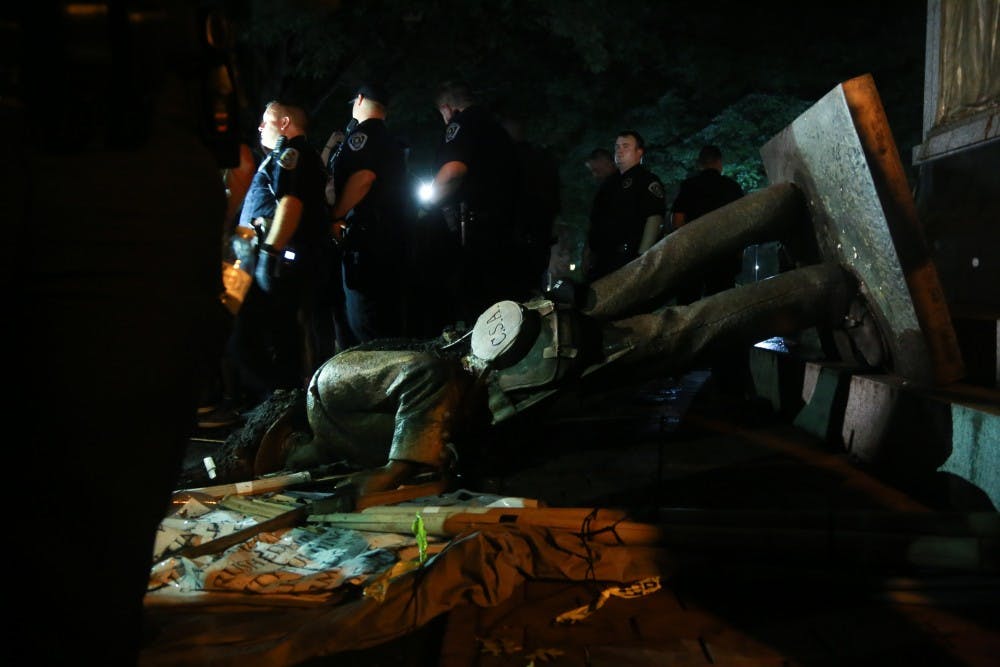 <p>Police surround Silent Sam on Aug. 20 after the Confederate monument was pulled down by demonstrators.&nbsp;</p>