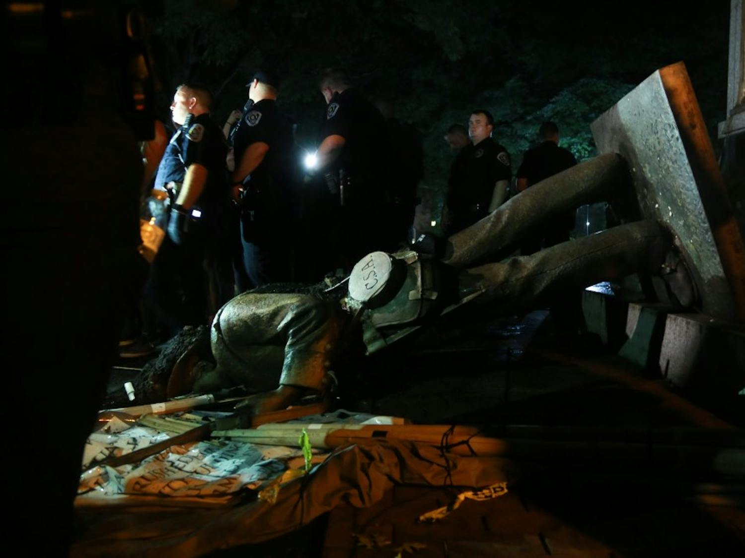 Police surround Silent Sam on Aug. 20 after the Confederate monument was pulled down by demonstrators.&nbsp;
