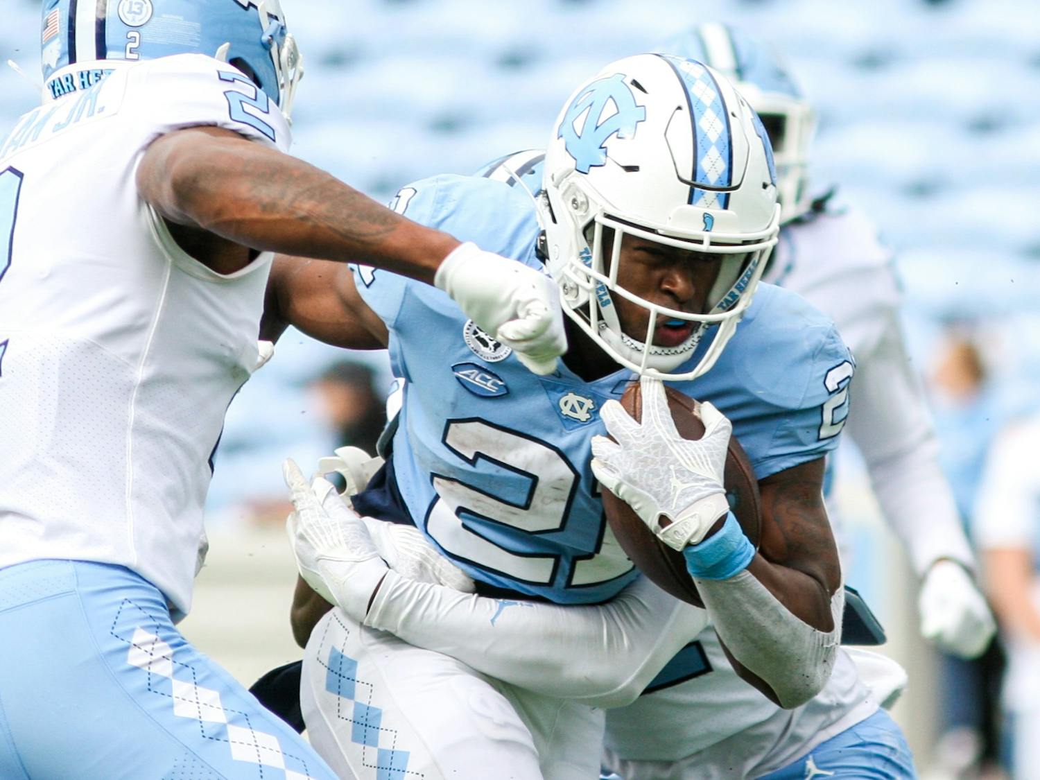 Sophomore running back Elijah Green (21) powers through the defensive line in the Spring Game on Saturday, April 9, 2022. The Tar Heels and Carolina tied, 14-14.