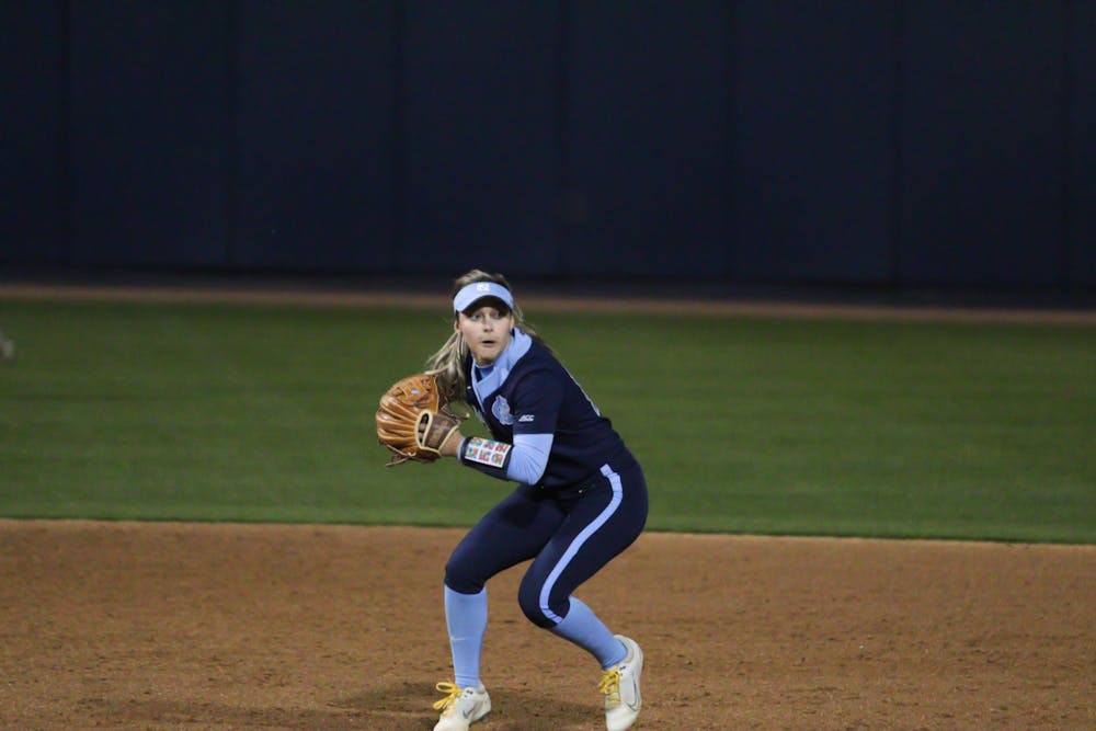 Graduate shortstop Sara Jubas (14)  goes to pass the ball to first base to get a Penn State runner out. The Heels lost 0-12 on Friday, March 4, 2022