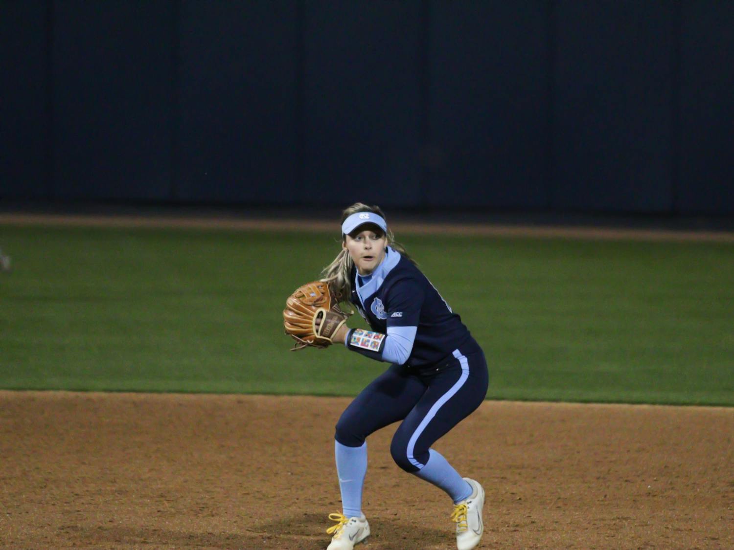 Graduate shortstop Sara Jubas (14)  goes to pass the ball to first base to get a Penn State runner out. The Heels lost 0-12 on Friday, March 4, 2022