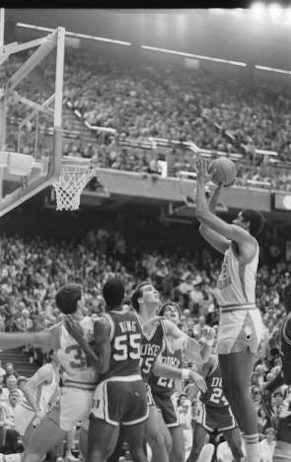 <p>Action shot during UNC v. Duke basketball game at opening of Dean Smith Activities Center, Chapel Hill, NC; UNC beat Duke 95-92. UNC's Brad Daugherty #42 going up for shot.</p>
<p>UNC v. Duke basketball, opening of Smith Center, in the Hugh Morton Photographs and Films #P0081, copyright January 18, 1986, North Carolina Collection, University of North Carolina at Chapel Hill Library.</p>