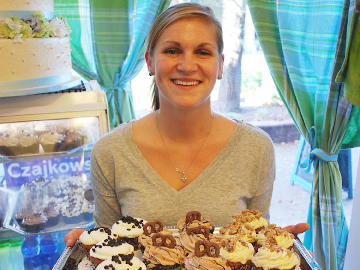 Local cupcake store Sugarland displays some of their fall cupcakesUNC exercise science student and Sugarland employee, Carley Brown displays some fall cupcakes (from left to right): Pumpkin Chocolate Chip, Oktoberfest, and Sweet Potato Praline