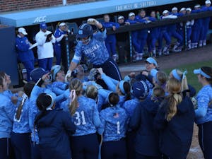 Senior Taylor Wike (7) is lifted up by her teammates after a home run against Kansas on March 3 in Anderson Stadium.