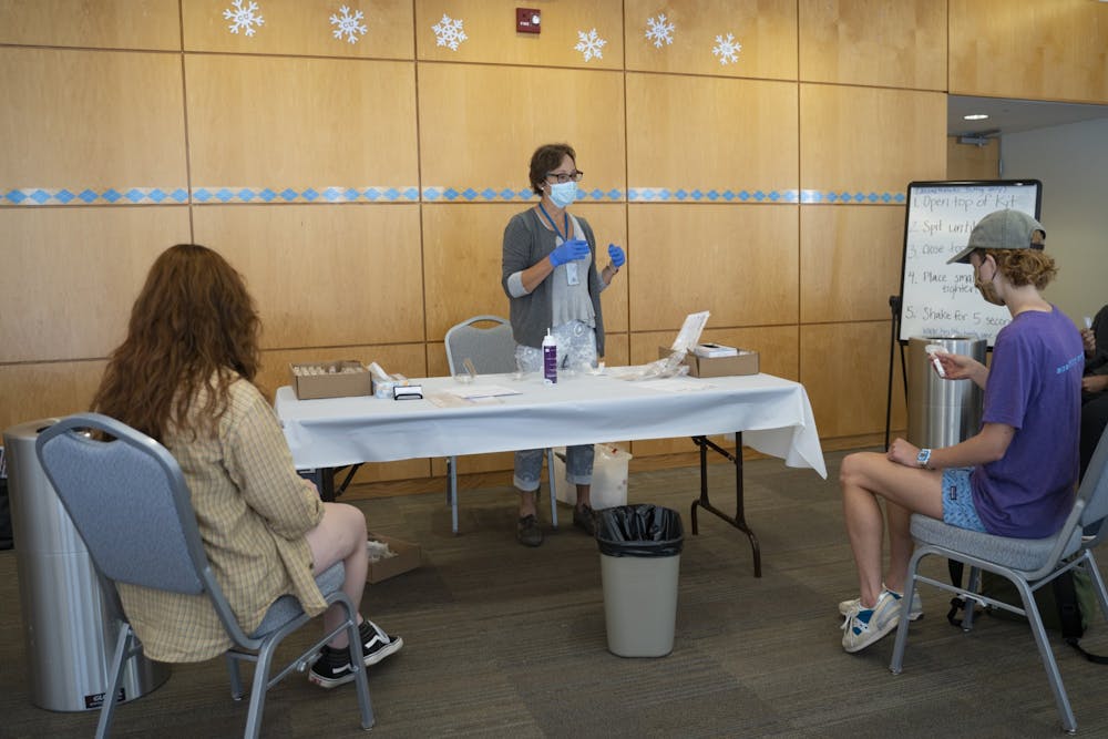 Nurse practitioner Jean McDonald administers COVID-19 saliva tests to students in the Student Union on Wednesday, Oct. 7, 2020.